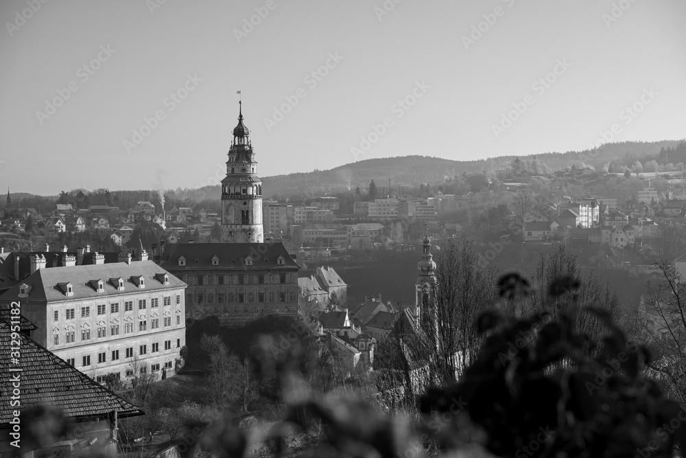 Castle tower and church in historical town Cesky Krumlov listed in UNESCO cultural heritage.