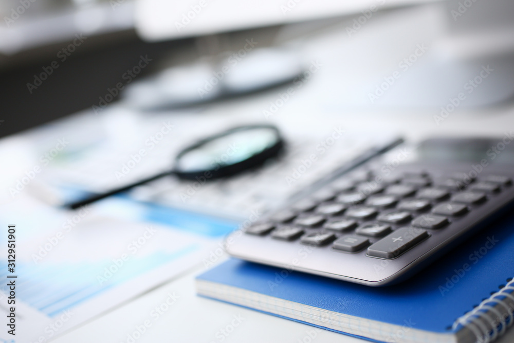 Silver calculator and financial statistics on clipboard Silver calculator and financial statistics on clipboard