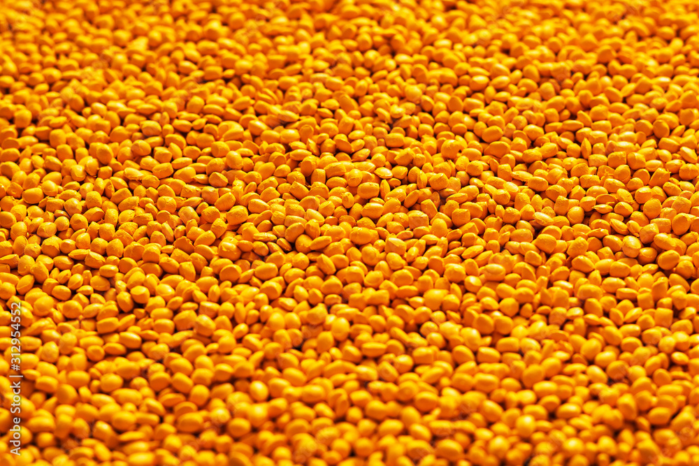 Yellow polymer dye in granules, background texture Yellow polymer dye in granules, background texture