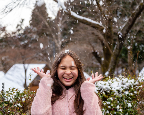  tween girl having fun in snow photo