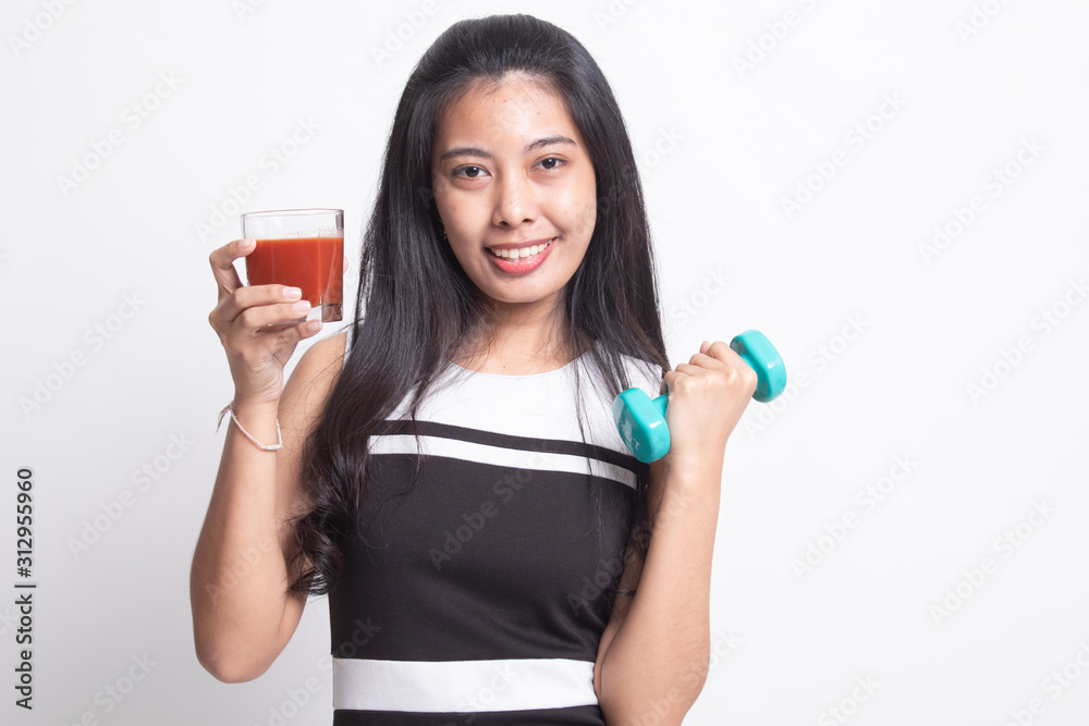 Healthy Asian woman with dumbbell and tomato juice. Healthy Asian woman with dumbbell and tomato juice.
