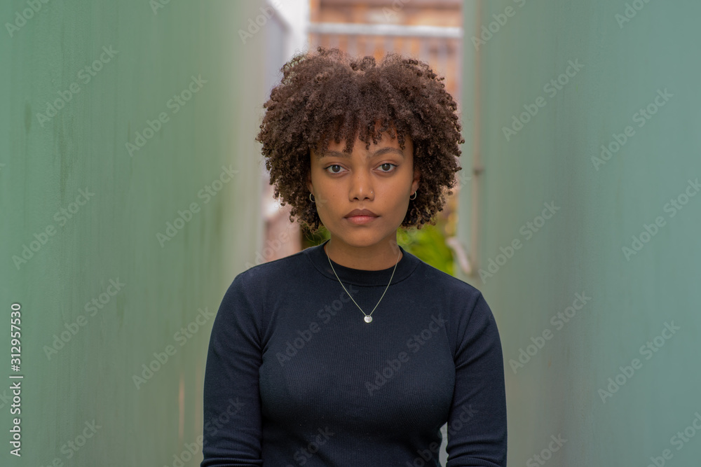 Young woman standing between two walls Young woman standing between two walls