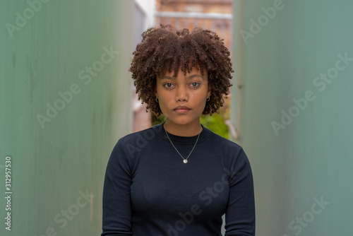 Young woman standing between two walls