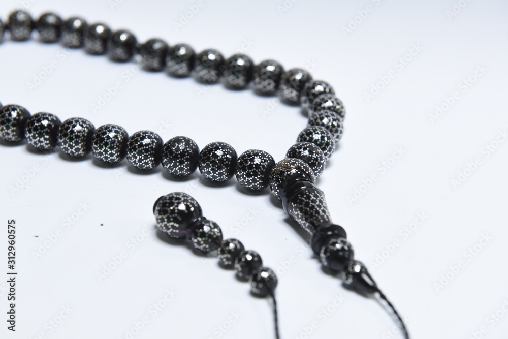 Handmade rosary necklace made of beads, black agate and silver on white Background Handmade rosary necklace made of beads, black agate and silver on white Background