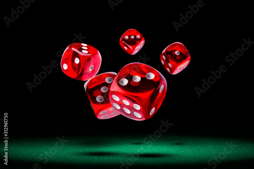 Red dice rolling on green felt