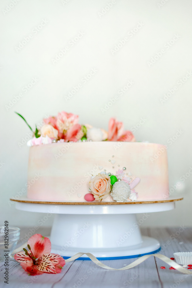 Delicate pink wedding cake with natural fresh beautiful flowers roses and lily. How To Put Fresh Flowers On A Buttercream Cake. Adding fresh flowers on a cake