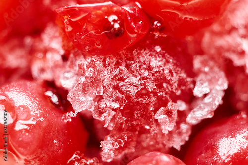 Abstract red winter background. Frozen red currants close-up. Blurred. Macro photo.