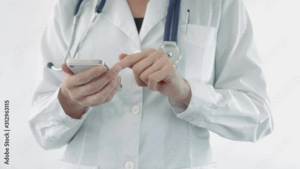 Doctor using a mobile phone. Texting. Woman. Lateral dolly. Doctor using a mobile phone. Texting. Woman. Lateral dolly.
