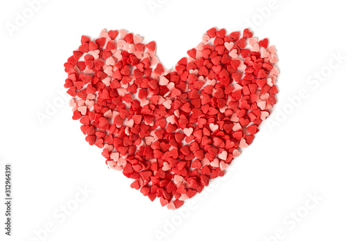 heart shape made from candy hundreds and thousands sprinkles on a white background