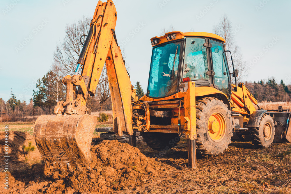 The excavator clears the ground to pave the road in private territory. The excavator clears the ground to pave the road in private territory.