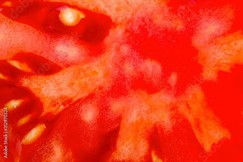 Food background. Slice of fresh red tomato. Detailed macro shot. Top view. © Dmytro Furman