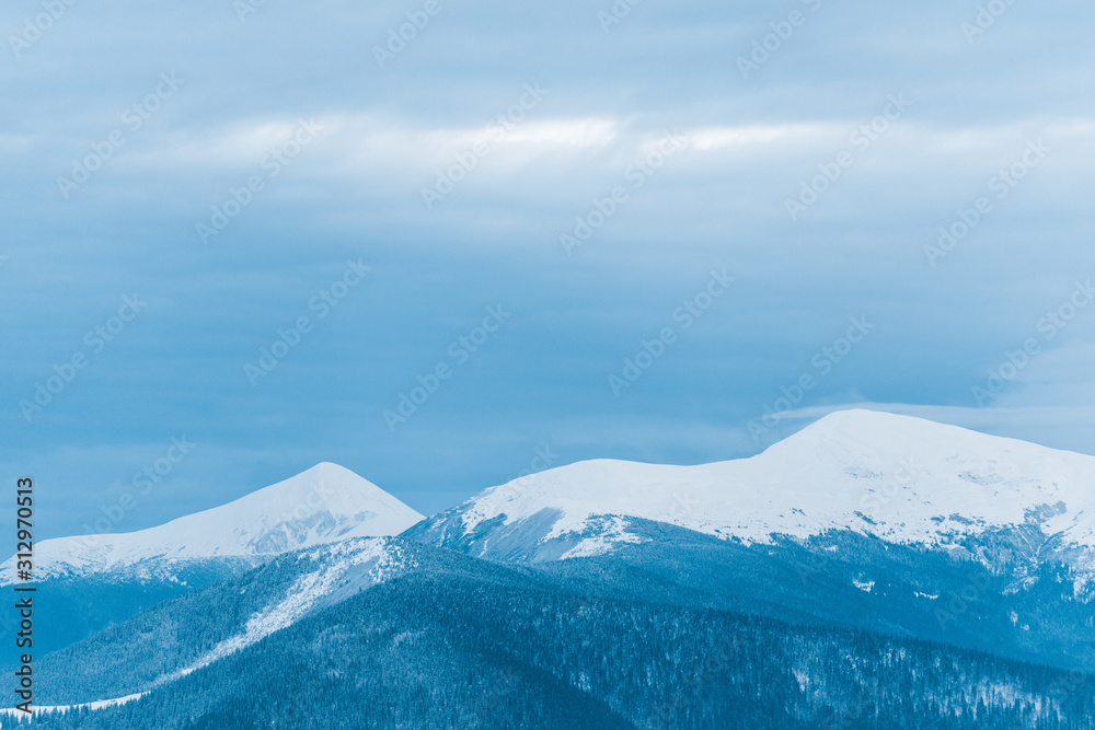 scenic view of snowy mountains and cloudy sky