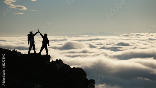 Photography silhouette of climber on top of mountain