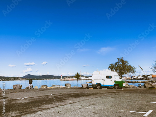 Small vintage van on the parking by the sea