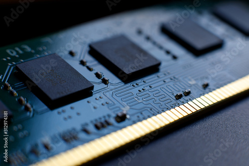 Contacts, connecting tracks and microchips of a computer RAM Random Access Memory modules close-up for electronic design. Selective focus. photo