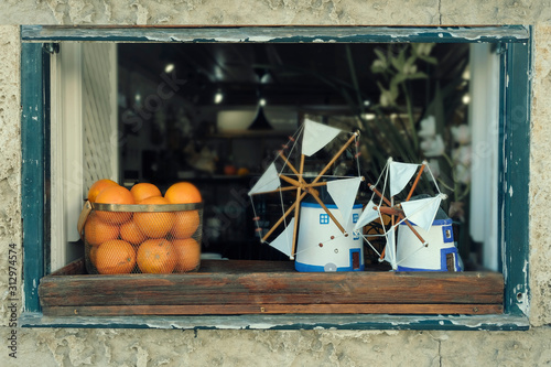  still life with oranges and toy souvenir windmills on the windowsill in the city of Obidos Portugal