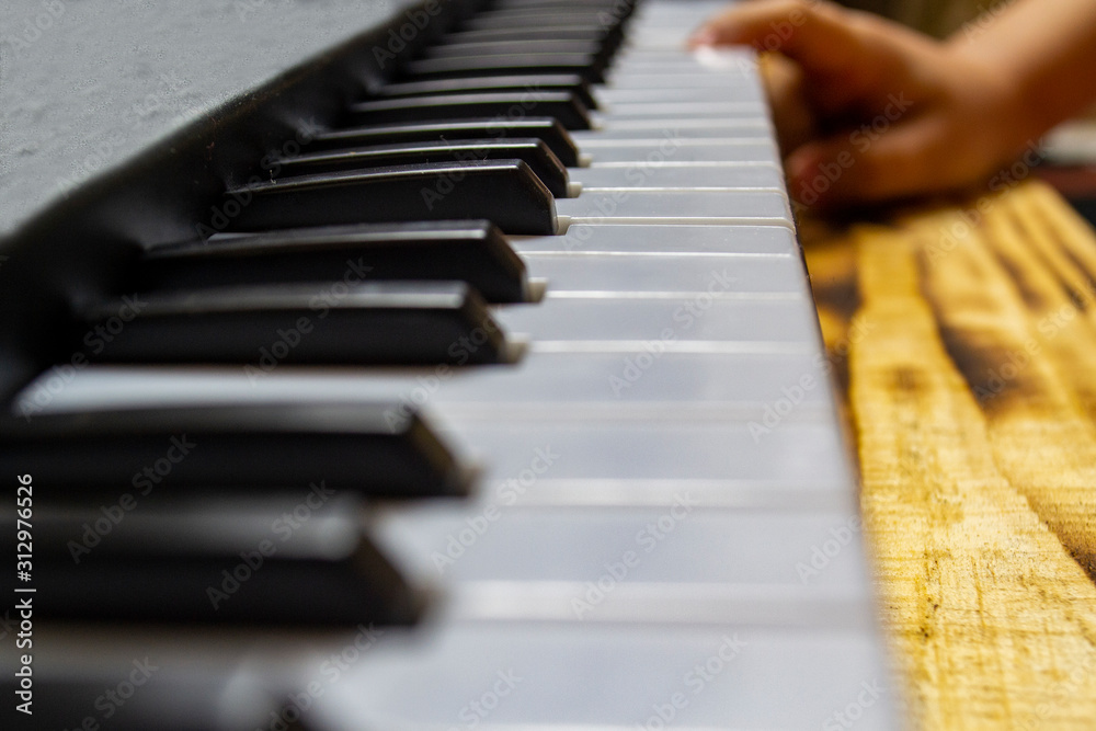 musician plays the piano, selective focus with shallow depth of field.