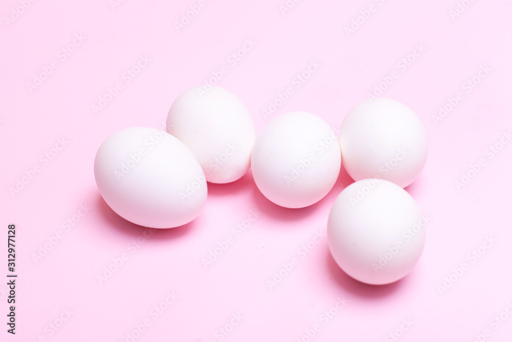 fresh white farm easter egg on pink/blue background. cooking/festive easter concept flat lay with copy space