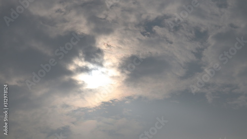 Grey white black monsoon clouds. Sun hidden in the sky. © Pranjal