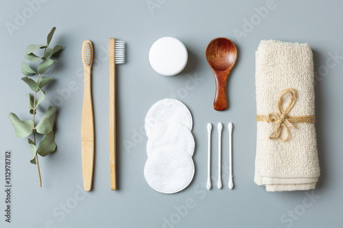 ecological beauty care products on a gray background. Bamboo toothbrush towel  earbuds