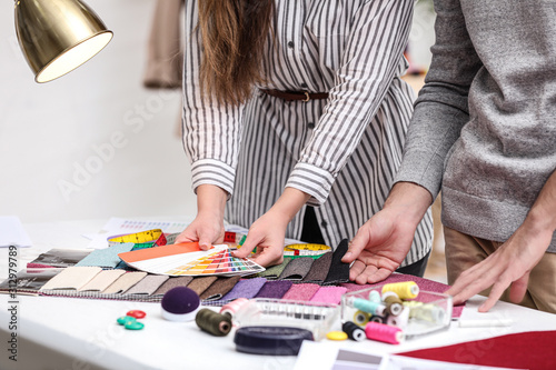 Obraz na płótnie Fashion designers creating new clothes in studio, closeup