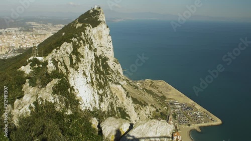 Daytime view of Gibraltar's rock. There is a shadow taking pcitures.