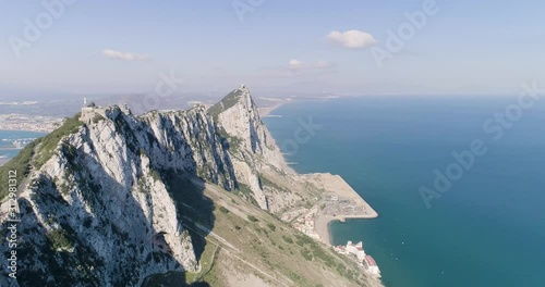 Aerial view of majestic Gibraltar's rock (UK oversea territory). There are flocks of birds flying. photo