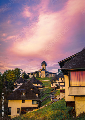 Medieval castle in cloudy colorful sunset photo