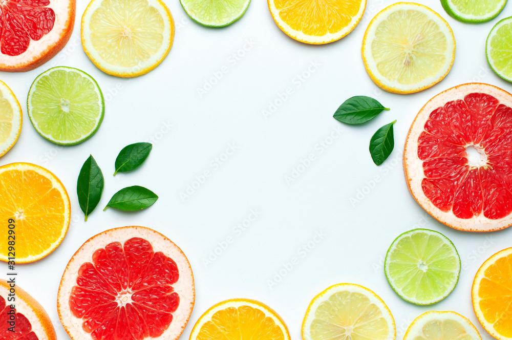 Flat lay composition with slices of fresh lemon orange grapefruit lime green leaves on white background top view copy space. Citrus Juice Concept, Vitamin C, Fruits. Creative summer background Flat lay composition with slices of fresh lemon orange grapefruit lime green leaves on white background top view copy space. Citrus Juice Concept, Vitamin C, Fruits. Creative summer background
