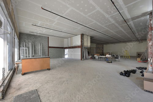 Under construction empty commercial retail space for rent with white walls 