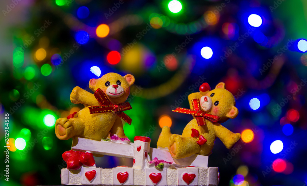 Fototapeta premium teddy bears in love on a swing in focus