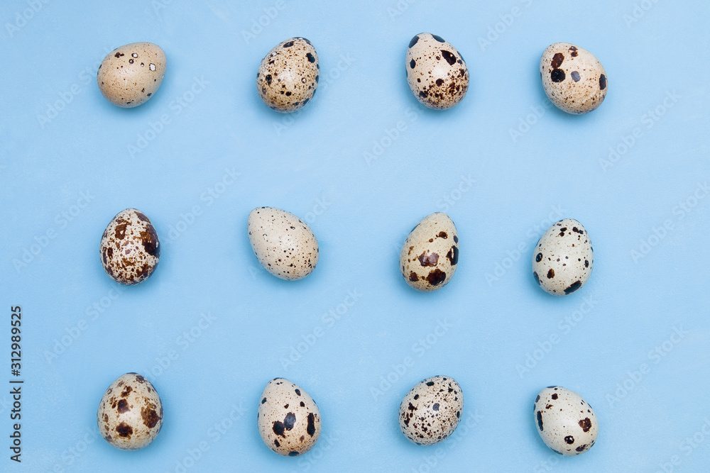 Pattern of quail eggs on a blue background. Minimal nutrition concept. easter background