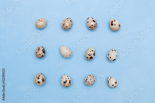 Pattern of quail eggs on a blue background. proper nutrition concept. easter background