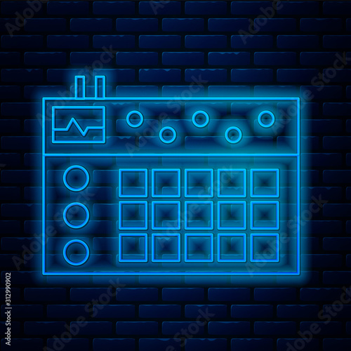 Glowing neon line Drum machine icon isolated on brick wall background. Musical equipment. Vector Illustration