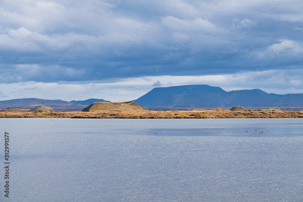 Idyllic landscape in soft colors, blue and yellow, Lake Mývatn in autumn colors, Iceland 