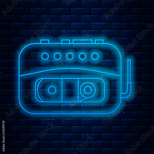 Glowing neon line Music tape player icon isolated on brick wall background. Portable music device. Vector Illustration