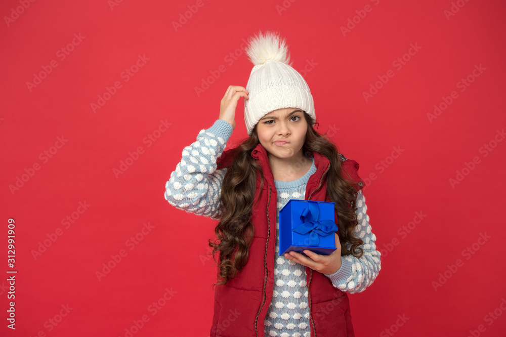 Online shopping. thoughtful kid in winter outfit red background. new year is coming. small gift box for child. christmas gifts and souvenirs. prepare for winter holidays. make pleasant things Online shopping. thoughtful kid in winter outfit red background. new year is coming. small gift box for child. christmas gifts and souvenirs. prepare for winter holidays. make pleasant things