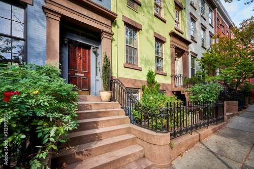 a view of a row of historic brownstones in an iconic neighborhood of Manhattan  New York City