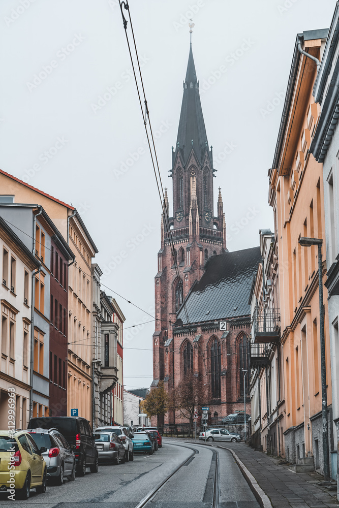 Street view of pointy clock tower of Paulskirche church in Schwerin near Hamburg, Germany