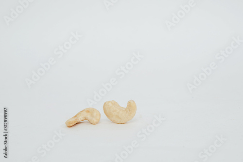 Cashews on a bright white background. The concept of eating nuts, giving them to a meal. photo