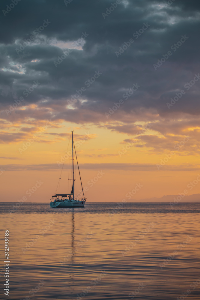 Small yacht in the red  sea at sunset in weilat ,israel 2019.
