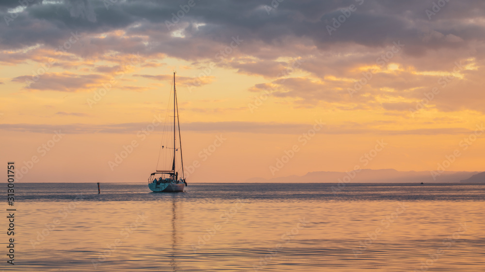 Small yacht in the red  sea at sunset in weilat ,israel 2019.