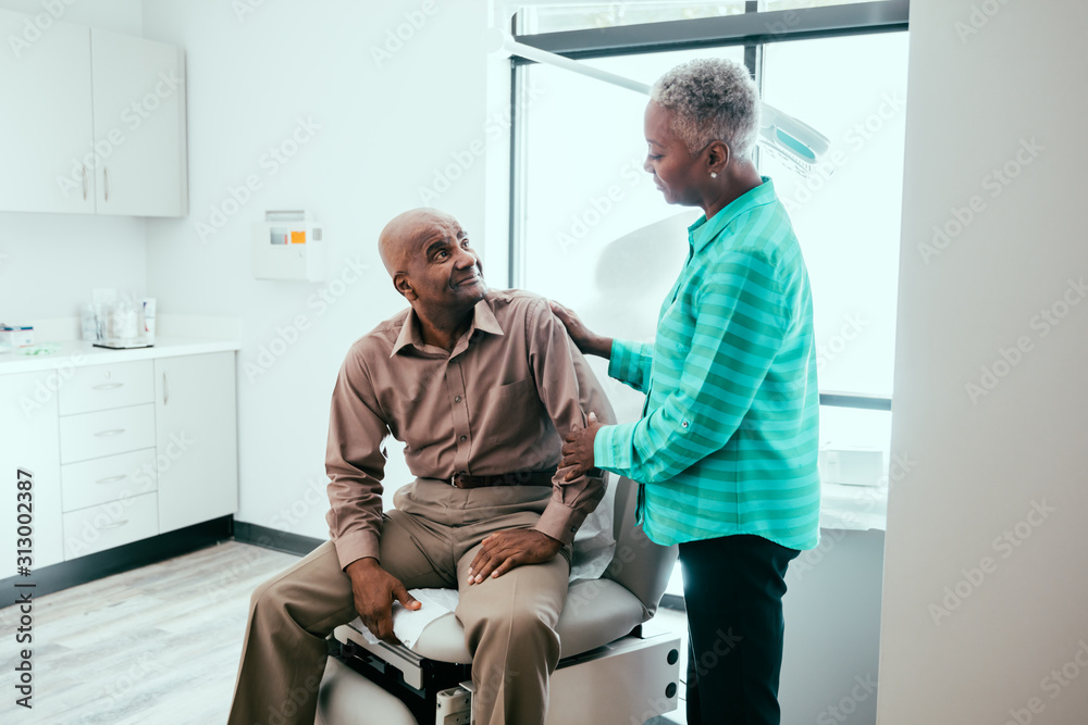 Mature couple waiting in exam room Mature couple waiting in exam room