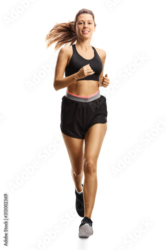 Young woman in shorts running