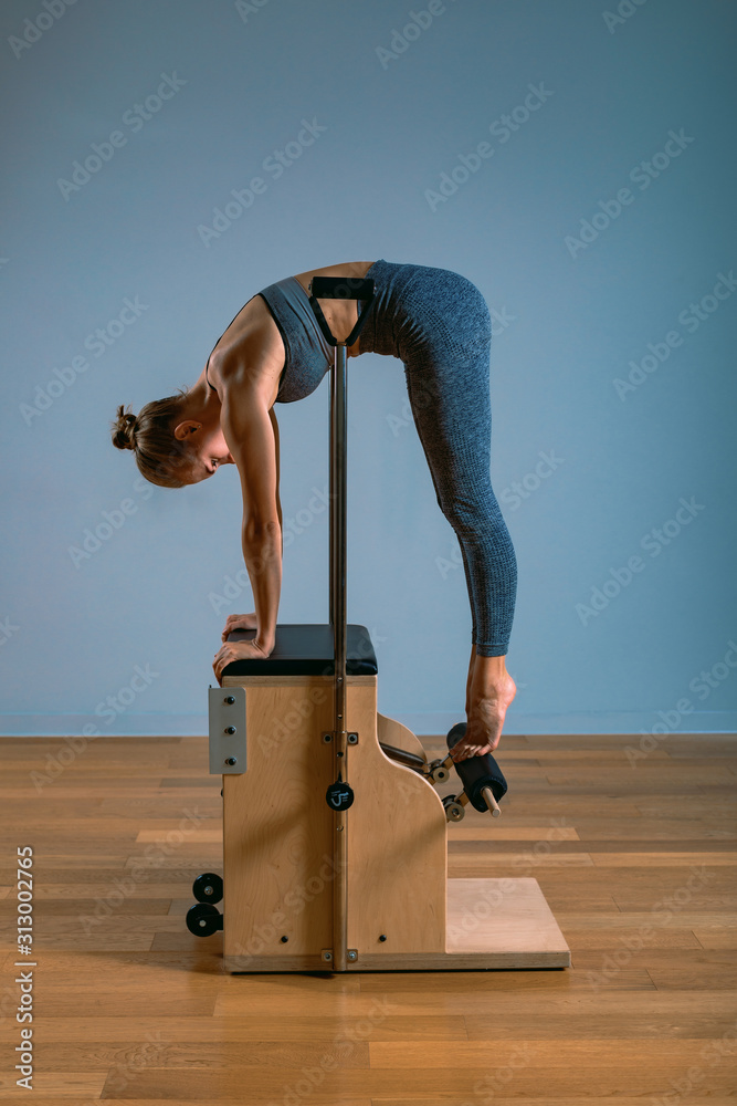 Woman is doing flexibility exercises. Pilates yoga athletic