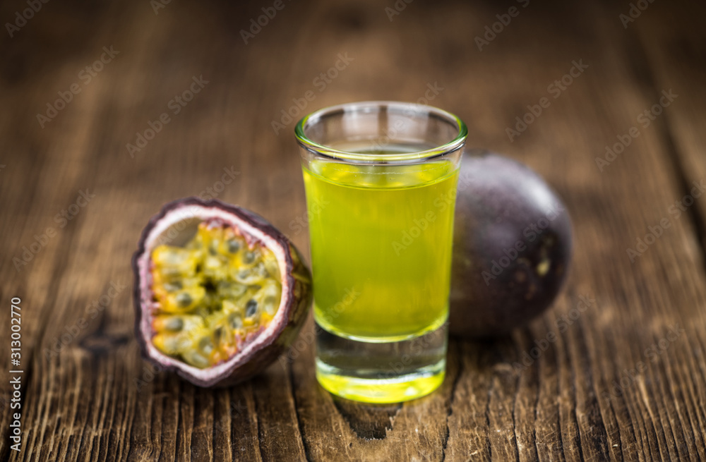 Some fresh Passion Fruit Liqueur on wooden background (selective focus; close-up shot) Some fresh Passion Fruit Liqueur on wooden background (selective focus; close-up shot)