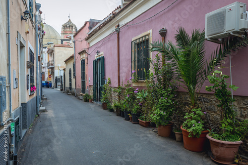 Fototapeta Naklejka Na Ścianę i Meble -  Plants in front of houses in Aci Castello town on Sicily Island, Italy