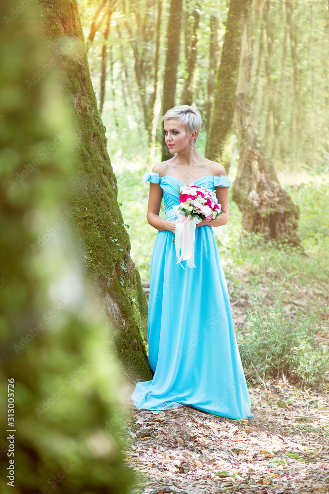 a couple in love, in the woods, a brunette guy and a blonde girl, on a romantic walk with flowers