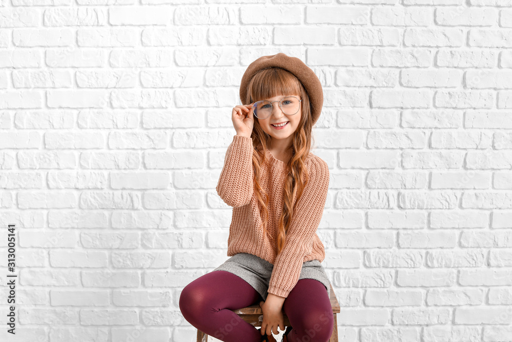 Cute fashionable girl near white brick wall Cute fashionable girl near white brick wall
