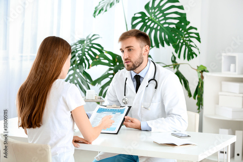 Male doctor working with fe...